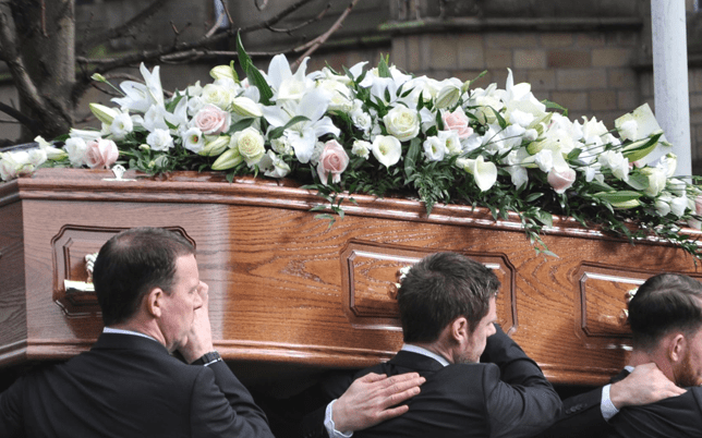 Coffin being lifted by gentlemen